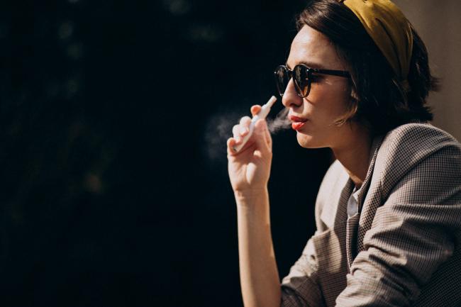 1.young-woman-sitting-smoking-ecigarette